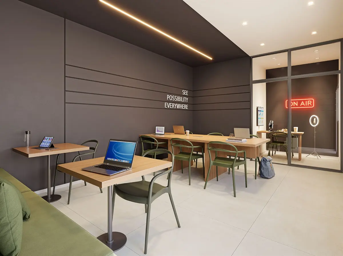 Coworking room at Breeze Inspire Residence, with individual desks and office chairs