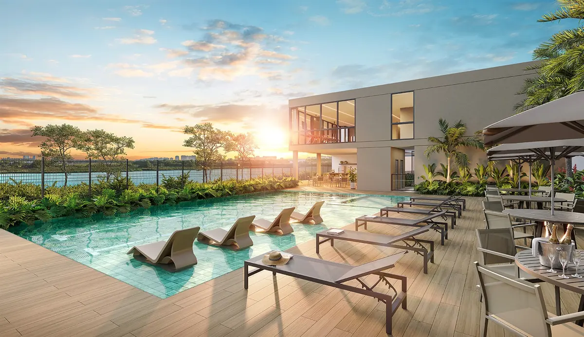The Breeze Inspire Residence pool in late afternoon light, with deck, loungers and the Barra lagoon behind
