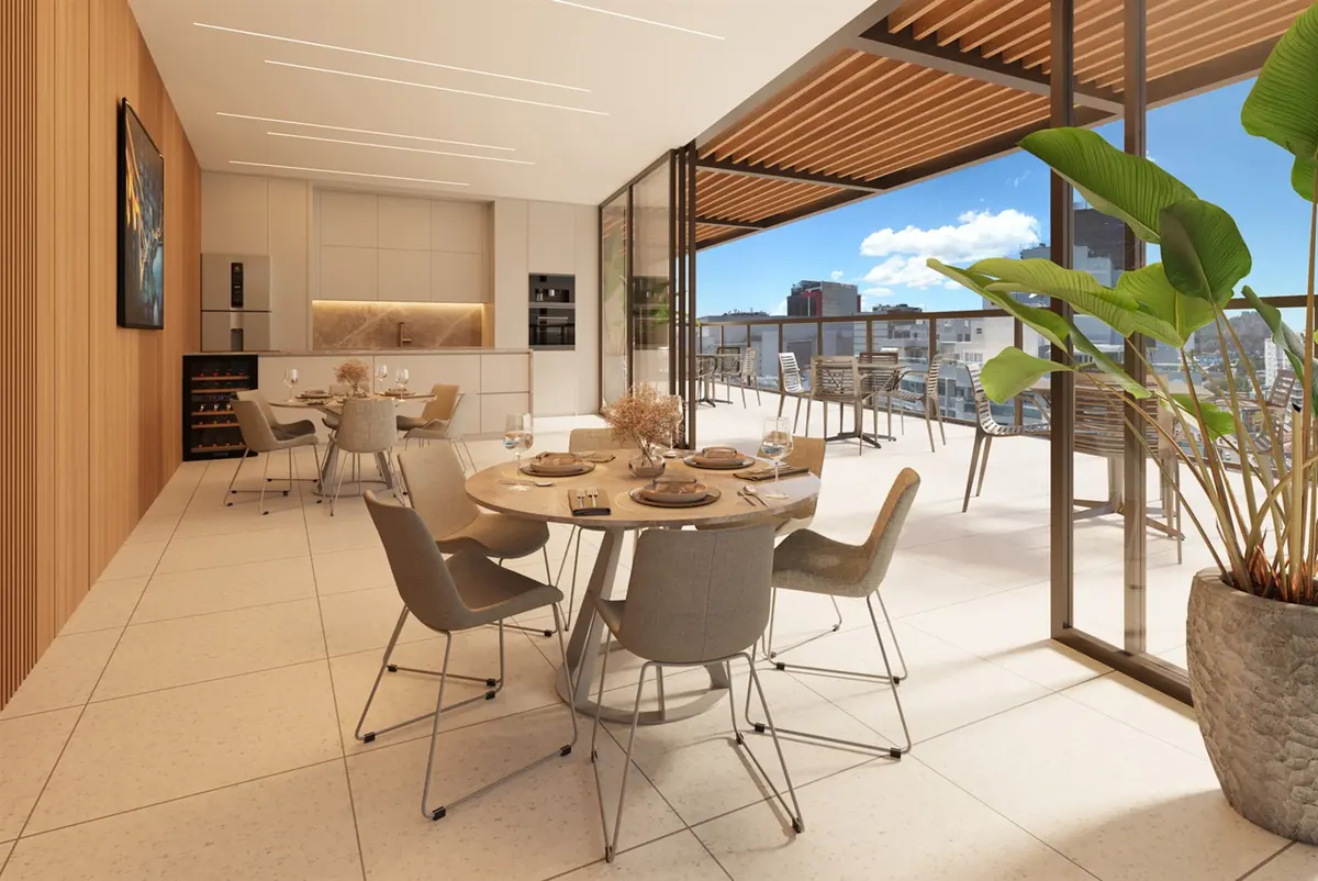 Espaço gourmet do Estação Botafogo, com mesa de jantar e porta de vidro para a varanda