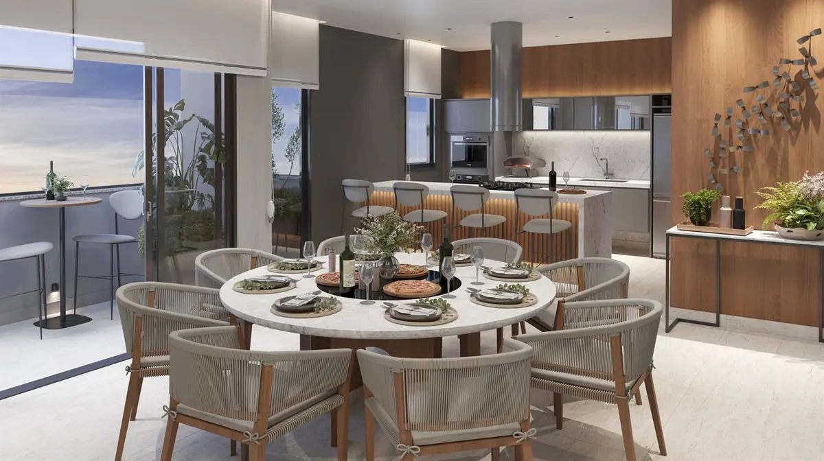 Espaço gourmet do Vitale Tide, com mesa posta, cozinha de apoio e vista para o jardim